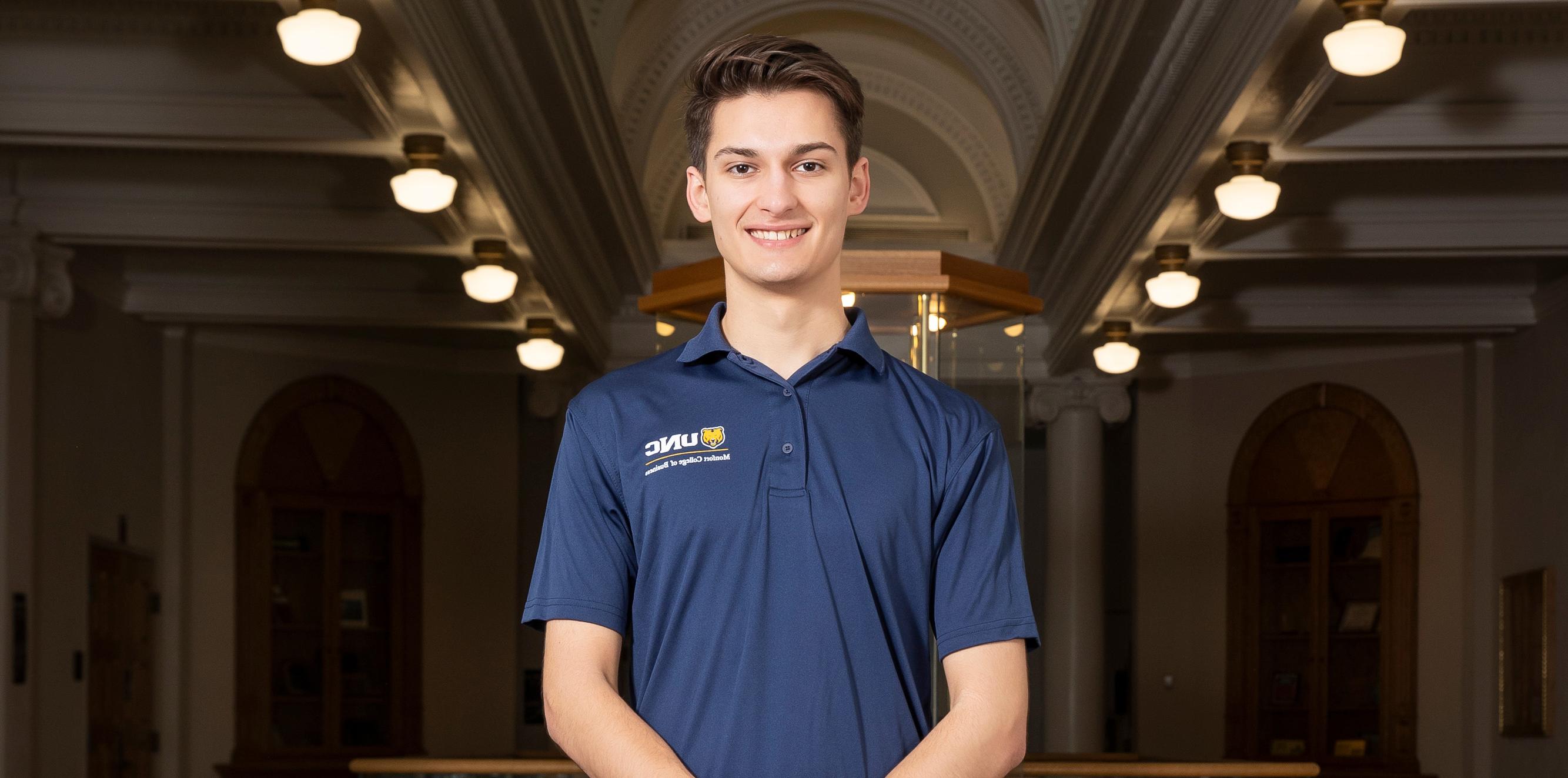 A profile shot of Philip Marshall wearing a navy polo shirt and smiling